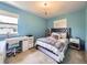 Stylish bedroom featuring a chandelier, a desk, and a comfortable bed at 3508 E 140Th Pl, Thornton, CO 80602