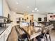 Bright kitchen and dining area with stainless appliances, white cabinets, and spacious island at 3508 E 140Th Pl, Thornton, CO 80602
