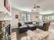 Comfortable living room with a stone fireplace, stylish rug, and ample natural light at 3508 E 140Th Pl, Thornton, CO 80602