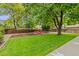 Large backyard with mature trees and a custom firepit at 1285 Aberdeen Dr, Broomfield, CO 80020
