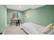 Green bedroom with natural lighting from the window and a vanity at 1285 Aberdeen Dr, Broomfield, CO 80020