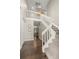 Inviting foyer with hardwood floors, a staircase with white railing, and a stylish light fixture at 1285 Aberdeen Dr, Broomfield, CO 80020