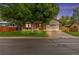 Charming brick home featuring mature landscaping, a well-manicured lawn, and an attached two-car garage at 1285 Aberdeen Dr, Broomfield, CO 80020
