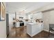 Modern kitchen with white cabinets, updated appliances, and a breakfast bar, creating a functional cooking space at 1285 Aberdeen Dr, Broomfield, CO 80020