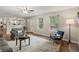 Bright living room filled with natural light, neutral paint, ceiling fan, and views to the backyard at 1285 Aberdeen Dr, Broomfield, CO 80020