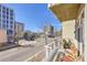 Balcony with outdoor seating overlooking city, offering views of the surrounding buildings and clear blue sky at 290 W 12Th Ave # 205, Denver, CO 80204