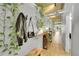 Bright hallway decorated with plants and coat rack, features hardwood floors and exposed concrete ceilings at 290 W 12Th Ave # 205, Denver, CO 80204