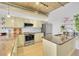 Modern kitchen with stainless steel appliances, granite countertops, light wood floors and exposed ceiling at 290 W 12Th Ave # 205, Denver, CO 80204