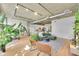 Bright and airy living room with hardwood floors, exposed ceilings, and lots of plants at 290 W 12Th Ave # 205, Denver, CO 80204