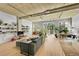 Spacious living room with a green sofa, multiple windows, and indoor plants at 290 W 12Th Ave # 205, Denver, CO 80204