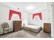 Simple bedroom with carpet flooring and natural light from the two windows at 7503 Saulsbury St, Arvada, CO 80003