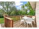 Cozy wooden deck with a white outdoor dining set, perfect for enjoying outdoor meals and gatherings at 7503 Saulsbury St, Arvada, CO 80003