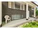 Inviting front porch of a brick home featuring classic columns and space to relax and enjoy the outdoors at 7503 Saulsbury St, Arvada, CO 80003