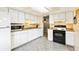 Efficient kitchen with white appliances, ample counter space, and well-lit cabinets for storage and food preparation at 7503 Saulsbury St, Arvada, CO 80003