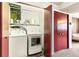 Practical laundry room equipped with a washer, dryer, storage shelf, and folding space at 7503 Saulsbury St, Arvada, CO 80003