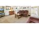 Cozy living room with comfortable seating, neutral carpet, and a seamless flow into the dining area at 7503 Saulsbury St, Arvada, CO 80003