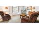 Comfortable living room with plush armchairs, neutral carpet, and natural light from the large window at 7503 Saulsbury St, Arvada, CO 80003