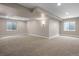 Finished basement area with recessed lighting, light gray carpeting, and two windows for natural light at 1757 Baguette Dr, Castle Rock, CO 80108