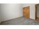Neutral bedroom featuring neutral carpeting, walls, and woodwork. A closet with sliding doors is in the background at 1757 Baguette Dr, Castle Rock, CO 80108