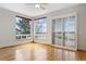 Bright bedroom with wood floors, a large window, and sliding glass door at 1757 Baguette Dr, Castle Rock, CO 80108