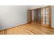 Bedroom with hardwood floors and views through glass french doors to the landing and staircase beyond at 1757 Baguette Dr, Castle Rock, CO 80108