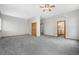 Large bedroom with ceiling fan, neutral walls, plush carpet, closet, and door to bathroom at 1757 Baguette Dr, Castle Rock, CO 80108