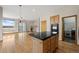 Kitchen island with black countertop view from living room with fireplace at 1757 Baguette Dr, Castle Rock, CO 80108
