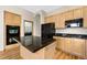 Eat-in kitchen featuring black countertops, wood cabinets, and black appliances at 1757 Baguette Dr, Castle Rock, CO 80108