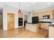 Kitchen with wood cabinets, black appliances, and a pendant light over the island at 1757 Baguette Dr, Castle Rock, CO 80108