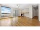 A naturally lit living room with a fireplace, hardwood floors, large windows, and sliding glass doors at 1757 Baguette Dr, Castle Rock, CO 80108
