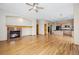 Bright living room with fireplace and wood floors open to the kitchen area at 1757 Baguette Dr, Castle Rock, CO 80108