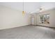 Spacious and empty living room with neutral walls, carpet, contemporary lighting, and plenty of natural light at 1757 Baguette Dr, Castle Rock, CO 80108