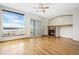 Open living room with fireplace, wood floors, large window, and sliding glass door at 1757 Baguette Dr, Castle Rock, CO 80108