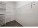 Bright walk-in closet with white walls, carpeted floor, and multiple levels of wire shelving to maximize storage at 1757 Baguette Dr, Castle Rock, CO 80108