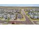 Aerial view of a suburban neighborhood with well-maintained homes, streets, and green spaces at 9479 Rifle St, Commerce City, CO 80022