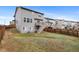 Spacious backyard with a wooden fence providing privacy, and a staircase leading to a deck at 9479 Rifle St, Commerce City, CO 80022