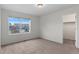 Bright, carpeted bedroom with large window and closet access at 9479 Rifle St, Commerce City, CO 80022
