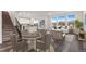 Inviting living space with dining area, kitchen, and large windows offering ample natural light at 9479 Rifle St, Commerce City, CO 80022