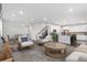 Open concept living space with modern kitchen, dining area, and comfortable seating at 9479 Rifle St, Commerce City, CO 80022