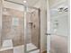 Modern tiled walk-in shower with seating and a glass door in the bathroom at 9479 Rifle St, Commerce City, CO 80022