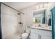 Bright bathroom featuring a shower with bronze fixtures, white cabinets, and granite countertops at 624 Stuart St, Denver, CO 80204