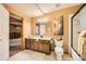 A tiled bathroom with a shower tub, framed mirror, and elegant fixtures and sunflower decor at 19375 Sherwood Trl, Monument, CO 80132