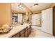 A well-lit bathroom with a large vanity, framed mirror, and a tub shower with glass doors at 19375 Sherwood Trl, Monument, CO 80132