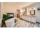 Luxurious bathroom with freestanding tub, fireplace, dual vanities, and modern fixtures at 19375 Sherwood Trl, Monument, CO 80132