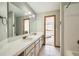 Well-lit bathroom features double sinks, a large mirror, and views into the bedroom at 19375 Sherwood Trl, Monument, CO 80132
