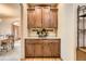Convenient butlers pantry with custom cabinetry, granite countertop, and tiled backsplash at 19375 Sherwood Trl, Monument, CO 80132