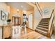 Spacious foyer featuring hardwood floors, a grand staircase, and an elegant chandelier at 19375 Sherwood Trl, Monument, CO 80132