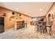 A large game room with a stylish bar, kitchenette, a dining table, and comfortable seating at 19375 Sherwood Trl, Monument, CO 80132