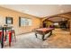 Entertaining game room featuring a pool table, breakfast nook, and a window with backyard view at 19375 Sherwood Trl, Monument, CO 80132
