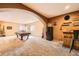 Game room featuring a bar, a pool table, a large lounging area, and rustic decor at 19375 Sherwood Trl, Monument, CO 80132